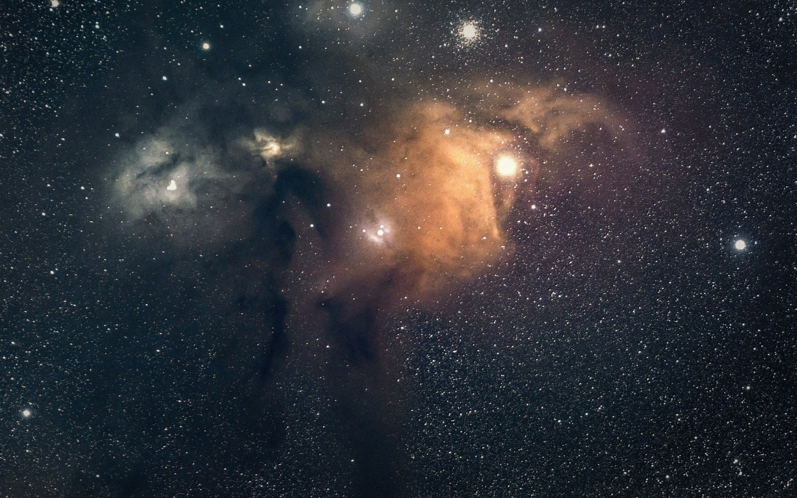 Orange and blue nebula clouds glow amid dense star fields against dark space