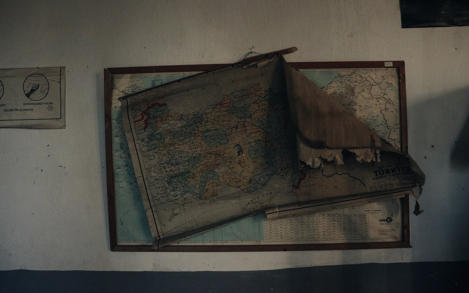 A worn paper star atlas open under a red light