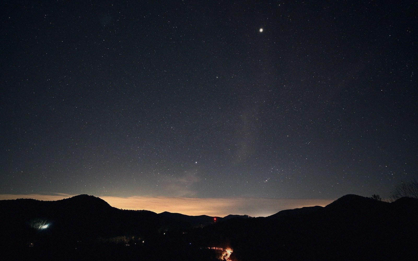 A telescope tube silhouetted against pre-dawn sky